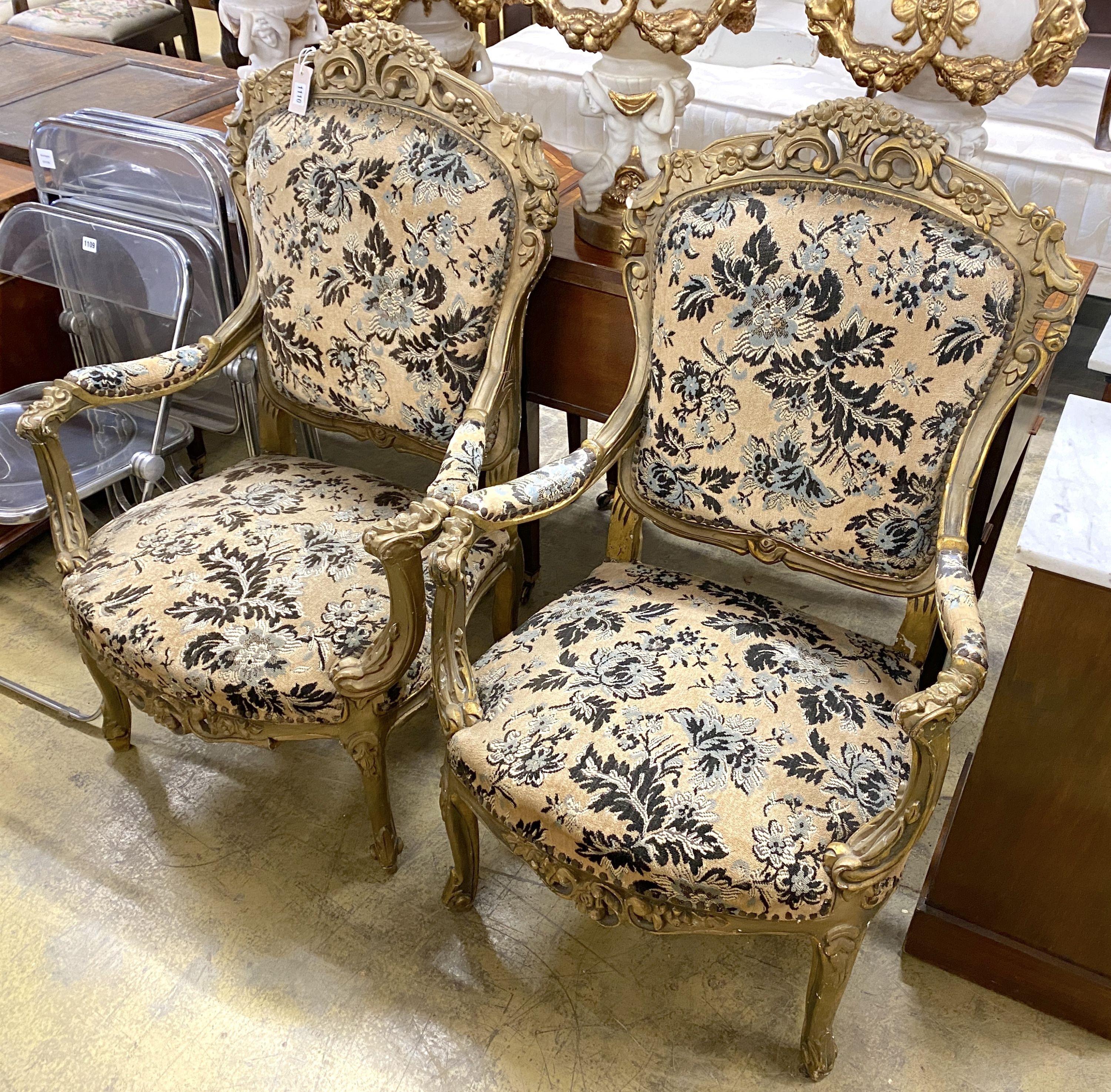 A pair of Louis XVI style carved giltwood upholstered open armchairs, width 72cm, depth 54cm, height 110cm